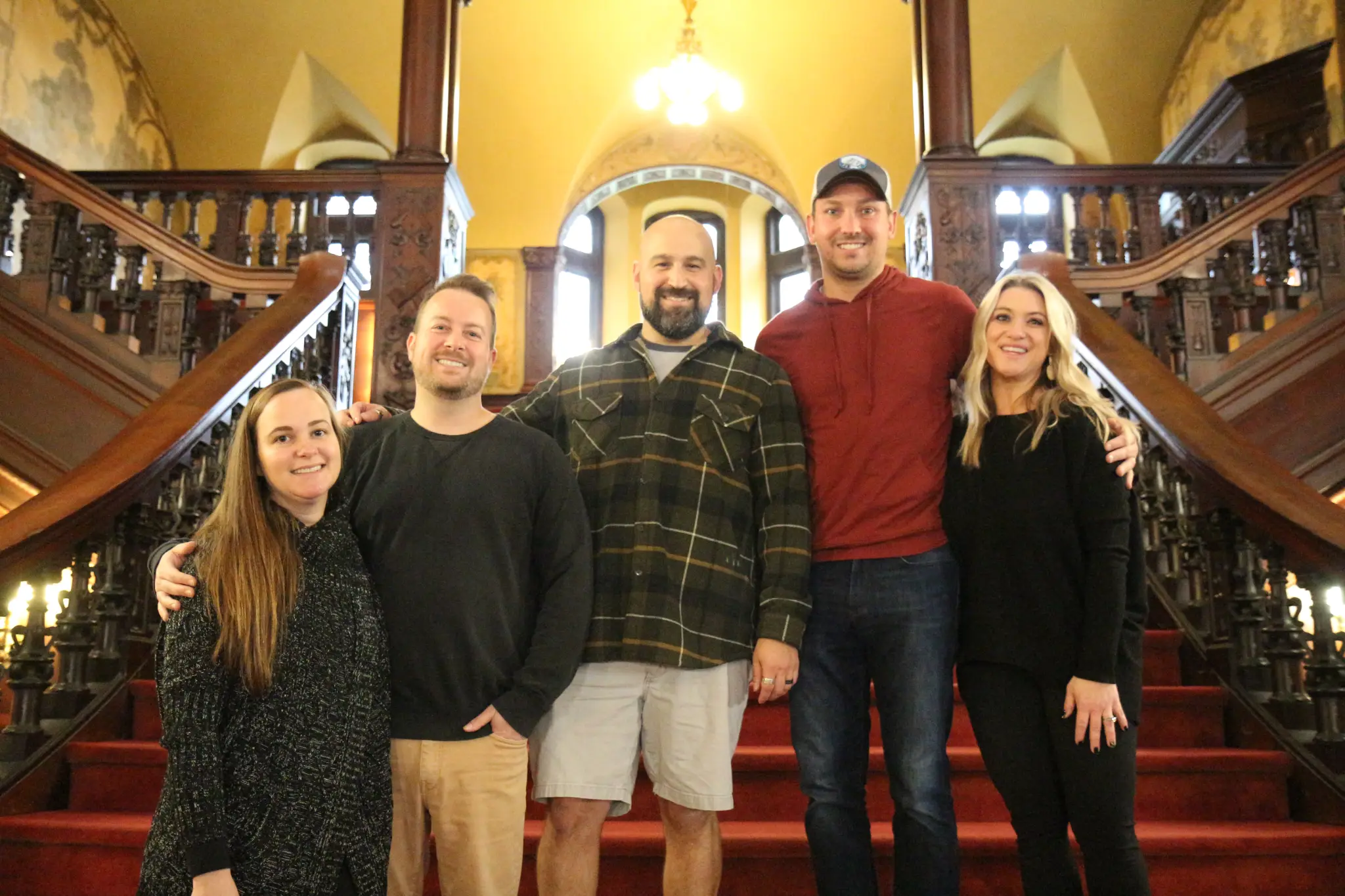 Five graduates from the Class of 2007 stand together on The Grey Towers Castle staircase.