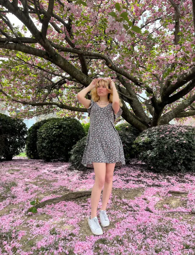 Zara under a blossoming tree.