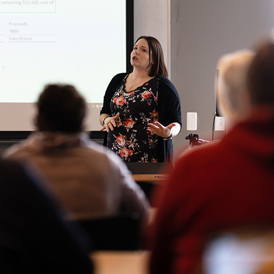 A teacher lectures during class at the School of Global Business