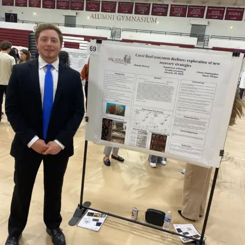 Mitchell Whitney '24 presents his capstone in the Kuch Alumni Gymnasium