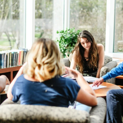 Students gather in chairs to read and discuss