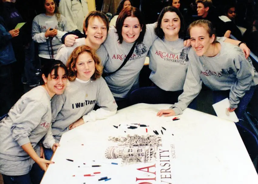 A vintage photo of Arcadia students working on a school banner.