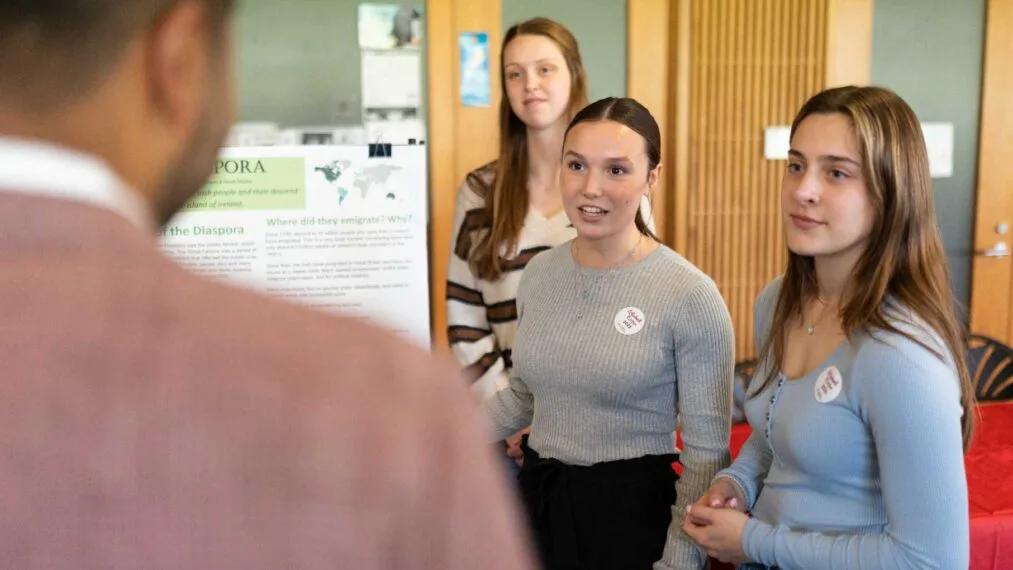 Four students talking during global expo.