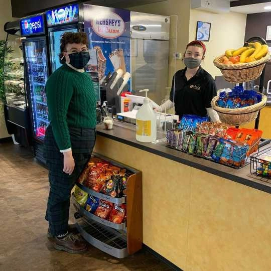 A customer at the check out lane of Dining Services Global Cafe