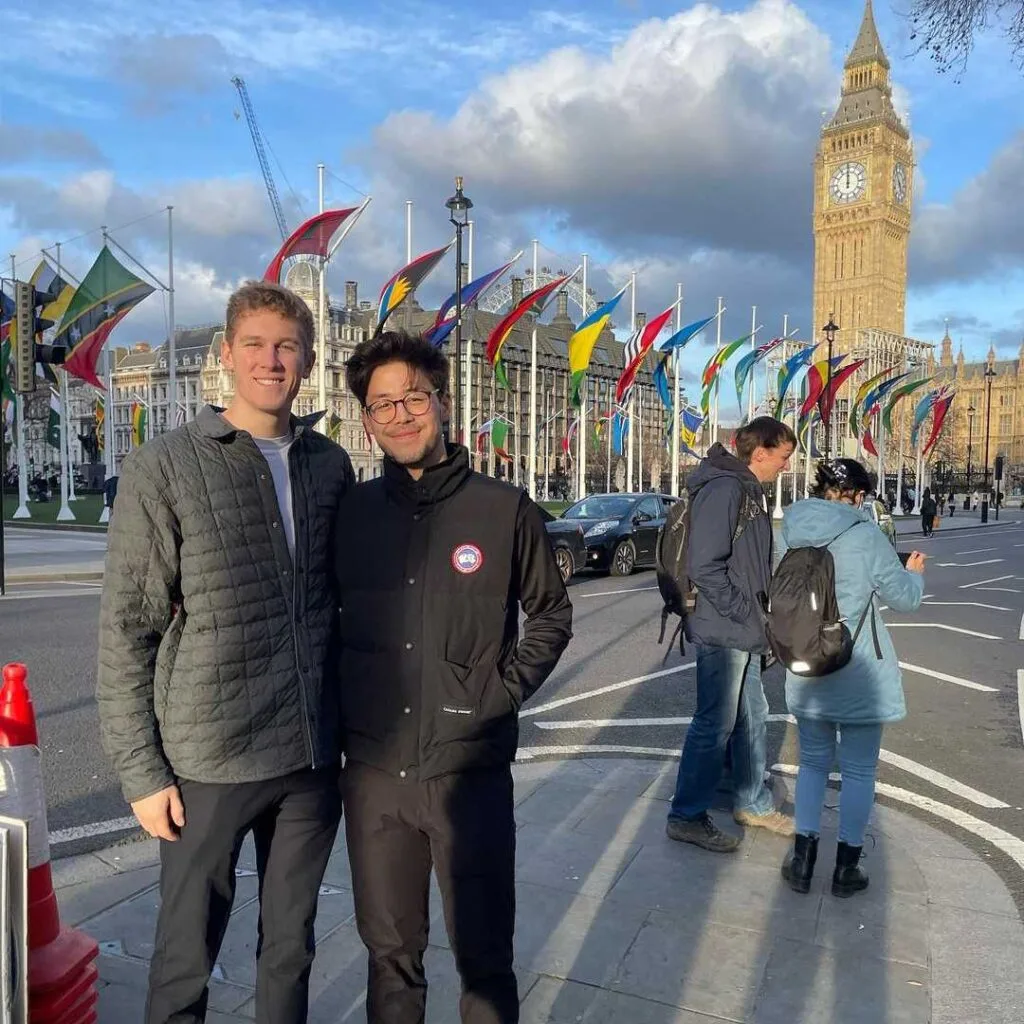 Two students pose in front of Elizabeth Tower in London