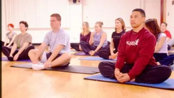 A group of people stretching on yoga mats