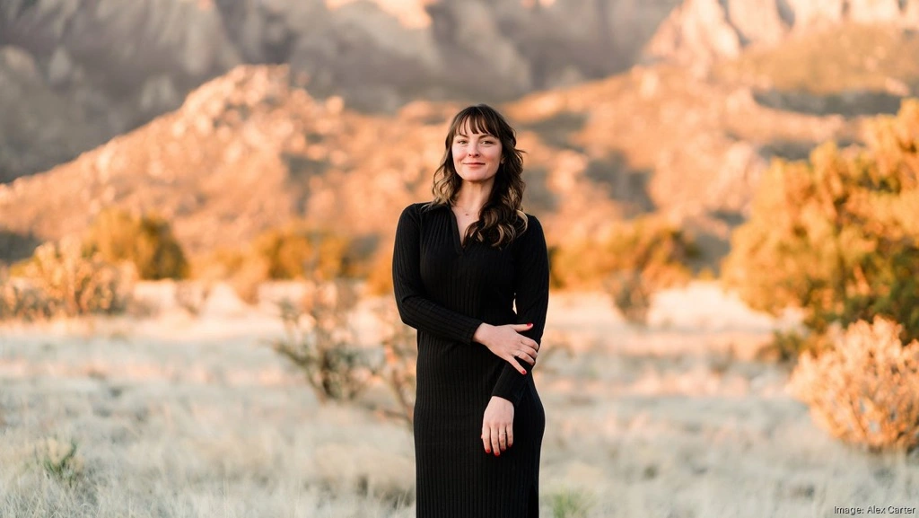 brown-haired girl standing in black dress amidst the New Mexico mountains and desert