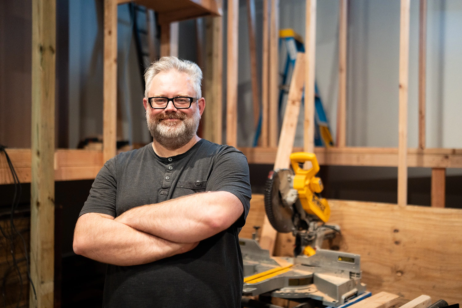 Director Matthew Borgen standing in front of a saw inside Spruance Gallery.