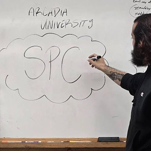 "Arcadia University SPC" written on a white board.