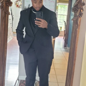 Aaron Lemons ’28 taking a selfie in a suit.