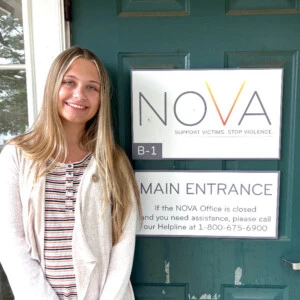 Kassidy Shaw ’27 standing at the entrance of the NOVA office in Jamison, Pa.