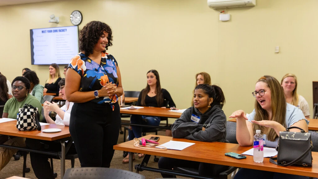 Lauren Reid, Ph.D., Director, Graduate Program in Counseling smiles as she talks to students in class.